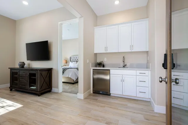 a kitchen with a refrigerator stove and white cabinets