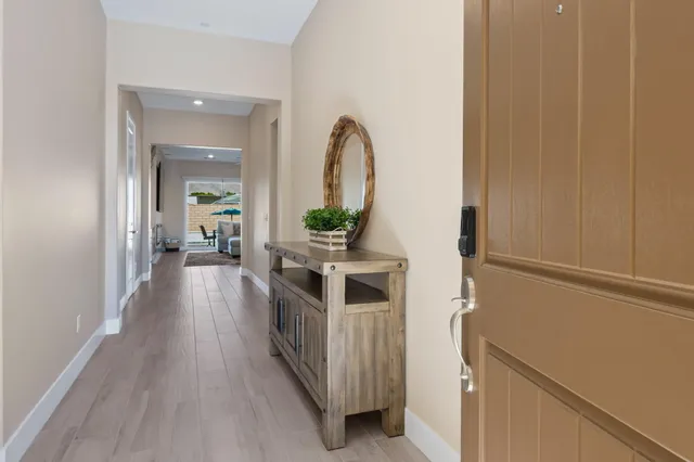 a view of a hallway with wooden floor and entryway