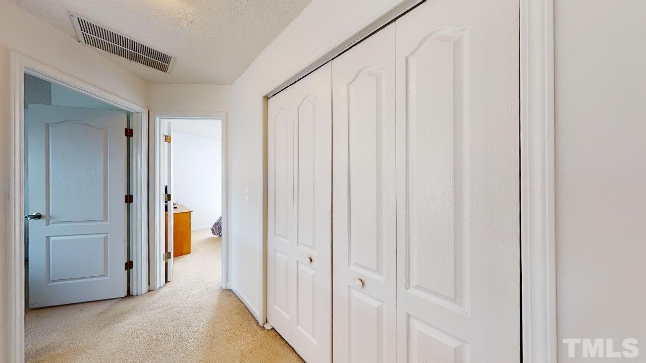 2901 Tuckland Drive Raleigh, NC 27610 - Photo 15 of 28 a view of a hallway with a wooden door