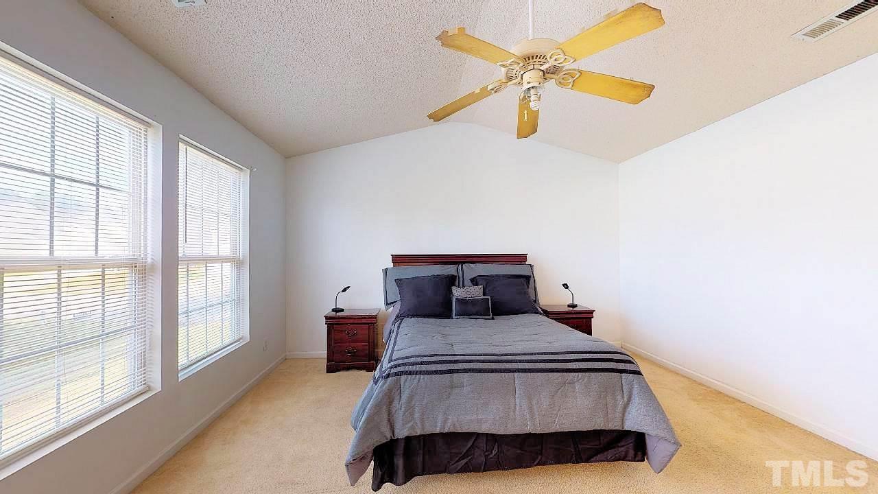 2901 Tuckland Drive Raleigh, NC 27610 - Photo 16 of 28 a bedroom with a bed and window