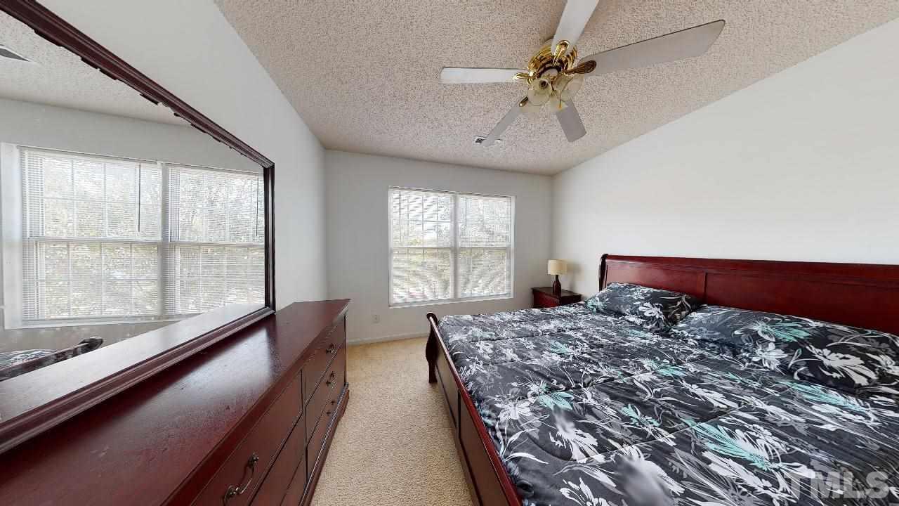 2901 Tuckland Drive Raleigh, NC 27610 - Photo 20 of 28 a bed sitting in a bedroom next to a window