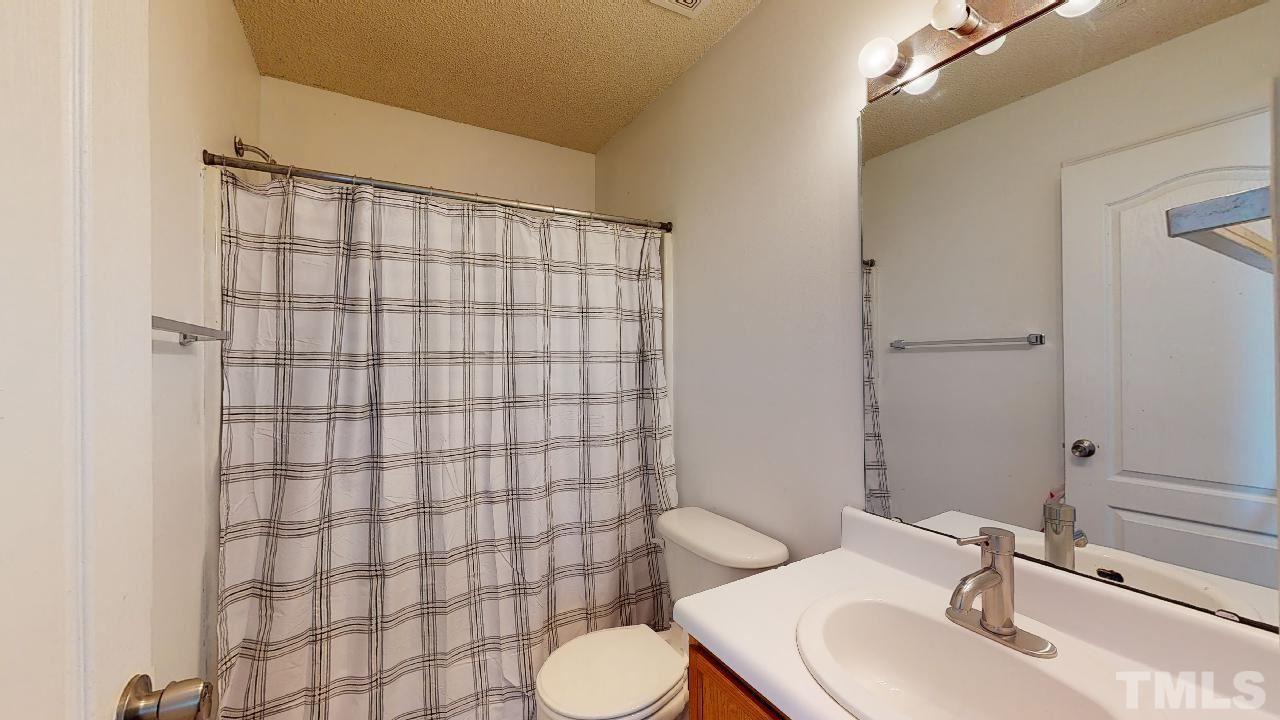 2901 Tuckland Drive Raleigh, NC 27610 - Photo 24 of 28 a bathroom with a sink toilet and shower