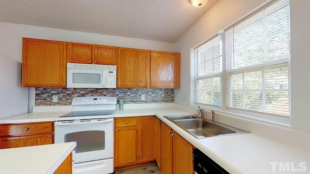 2901 Tuckland Drive Raleigh, NC 27610 - Photo 5 of 28 a kitchen with a sink stove top oven and cabinets