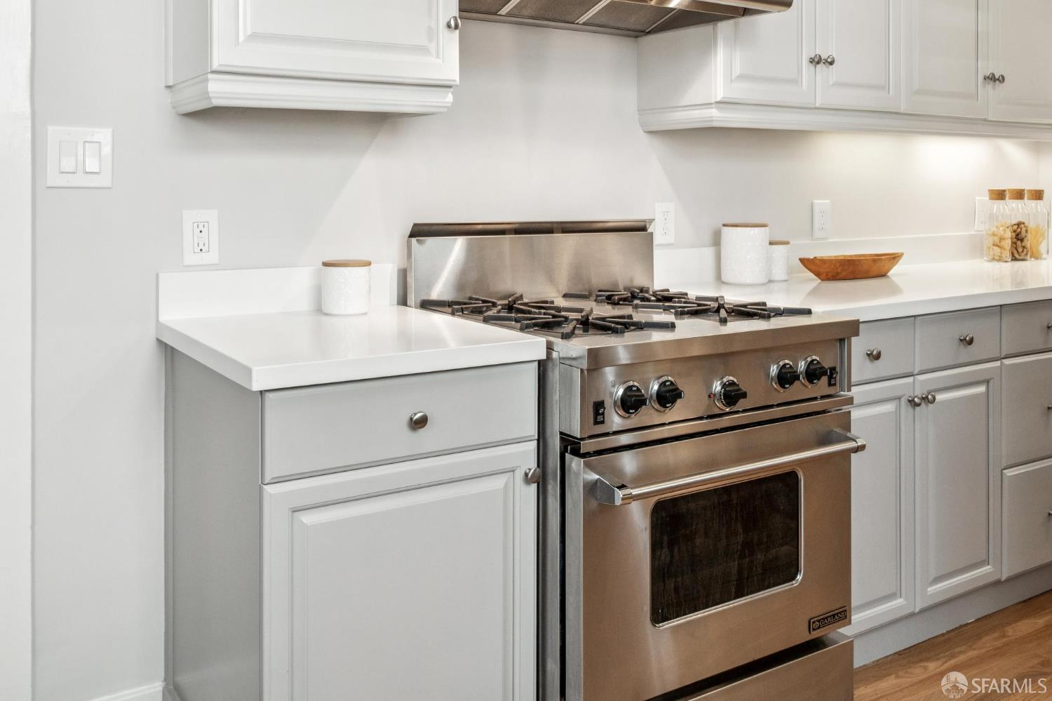 2522 Chestnut Street San Francisco, CA 94123 - Photo 18 of 34 a kitchen with stove top oven and cabinets
