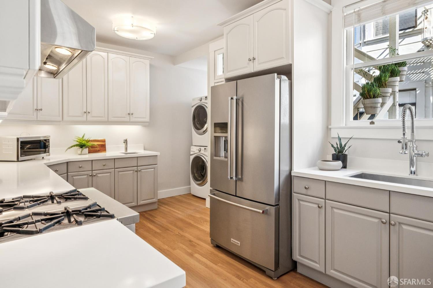 2522 Chestnut Street San Francisco, CA 94123 - Photo 20 of 34 a kitchen with white cabinets and stainless steel appliances