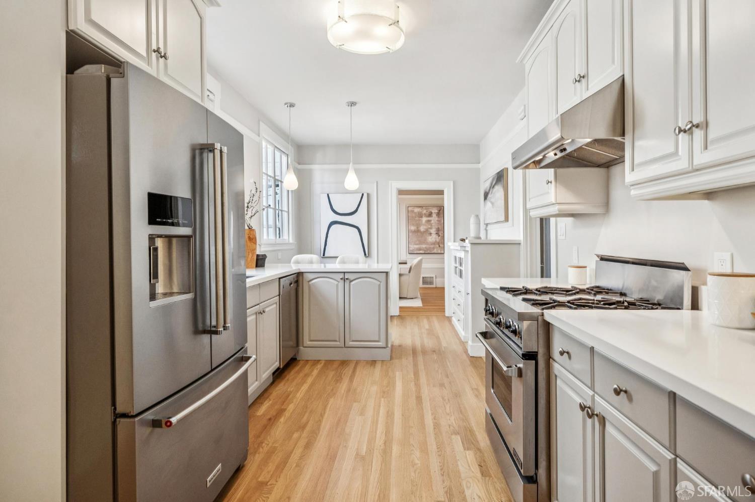 2522 Chestnut Street San Francisco, CA 94123 - Photo 22 of 34 a kitchen with a stove a sink and a refrigerator