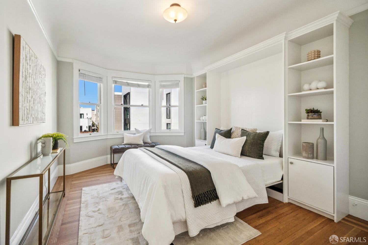 2522 Chestnut Street San Francisco, CA 94123 - Photo 27 of 34 a bedroom with a bed and wooden floor