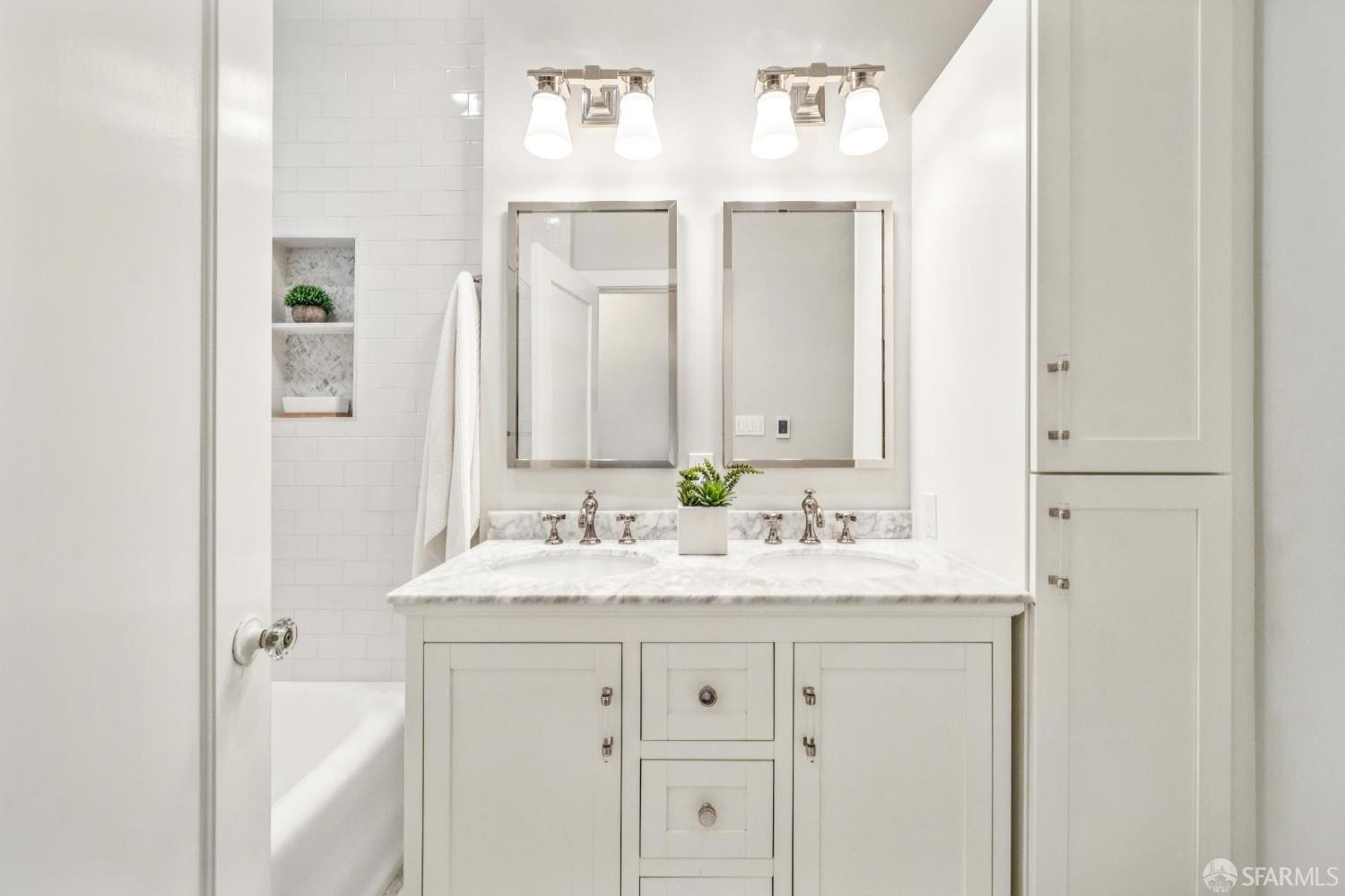 2522 Chestnut Street San Francisco, CA 94123 - Photo 31 of 34 a bathroom with a sink and a mirror