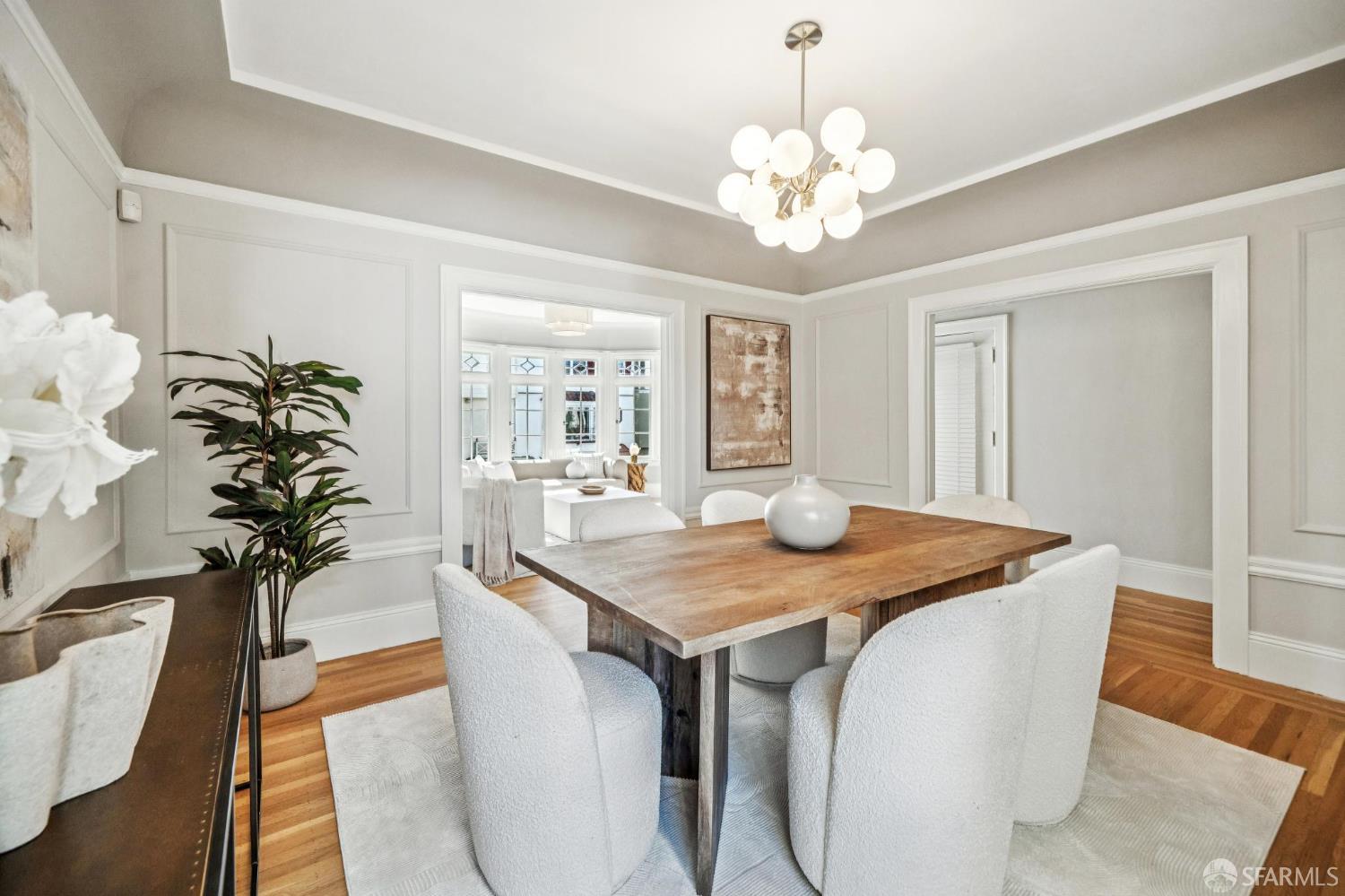 2522 Chestnut Street San Francisco, CA 94123 - Photo 9 of 34 a dining room with chandelier and wooden floor