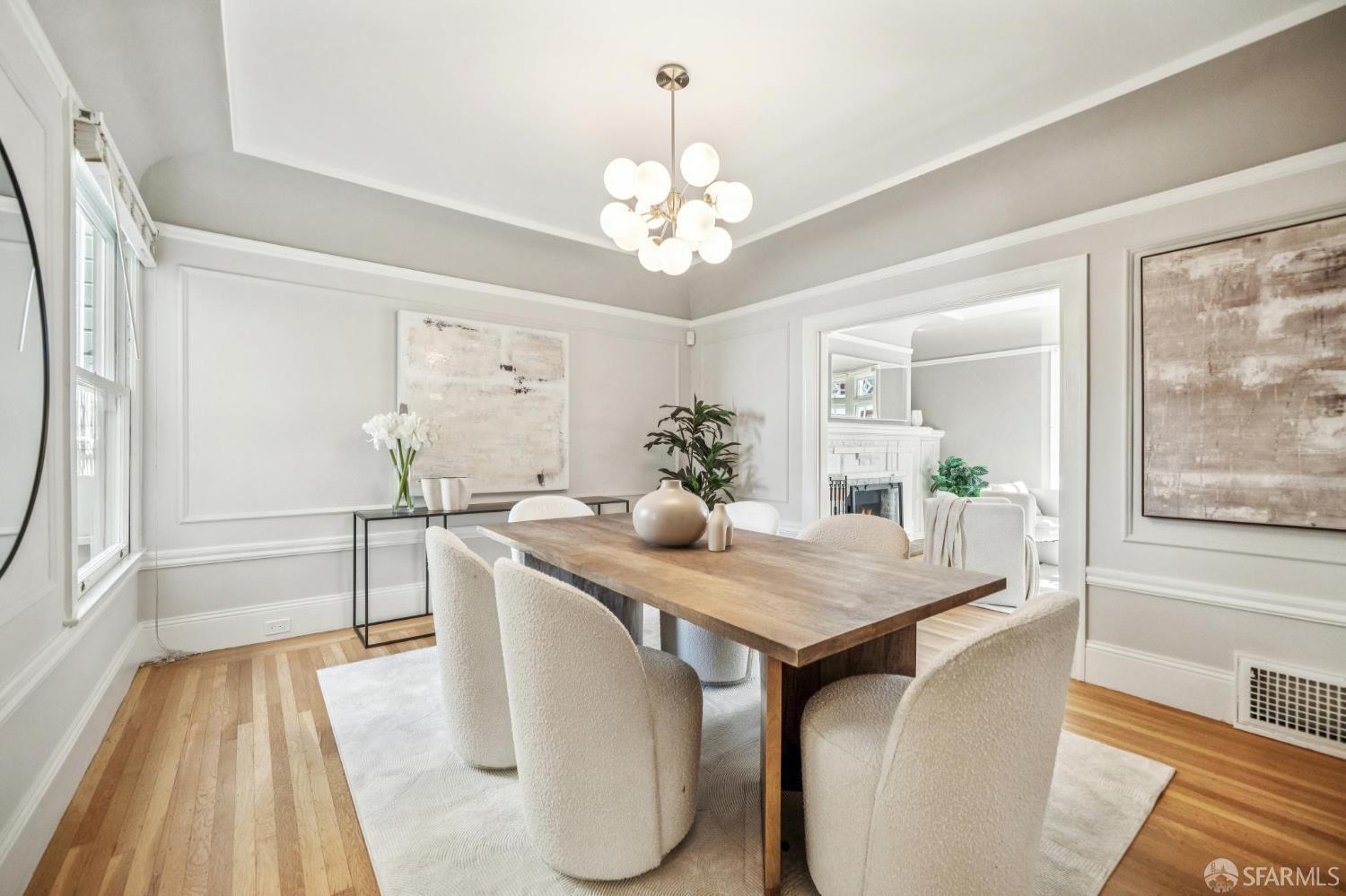 2522 Chestnut Street San Francisco, CA 94123 - Photo 10 of 34 a dining room with wooden floor a chandelier a wooden table and chairs