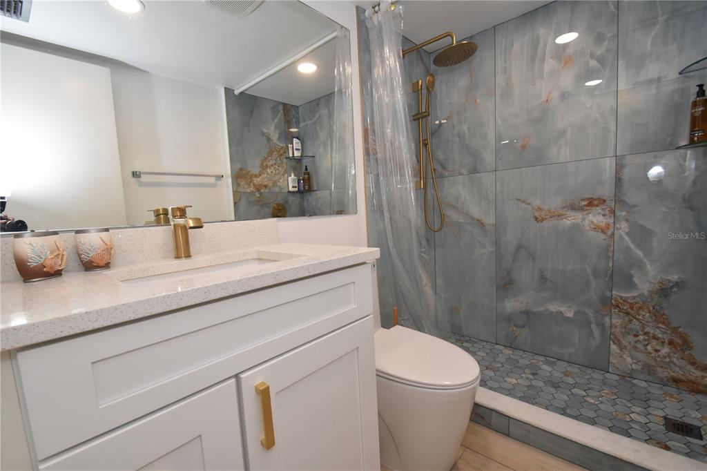 1720 Glenhouse Drive, Unit GL429 Sarasota, FL 34231 - Photo 11 of 34 a bathroom with a sink a toilet and shower