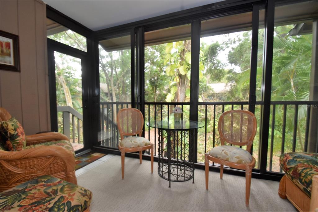1720 Glenhouse Drive, Unit GL429 Sarasota, FL 34231 - Photo 12 of 34 a living room with furniture and a floor to ceiling window