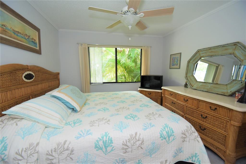 1720 Glenhouse Drive, Unit GL429 Sarasota, FL 34231 - Photo 13 of 34 a bedroom with a bed and a mirror on the dresser