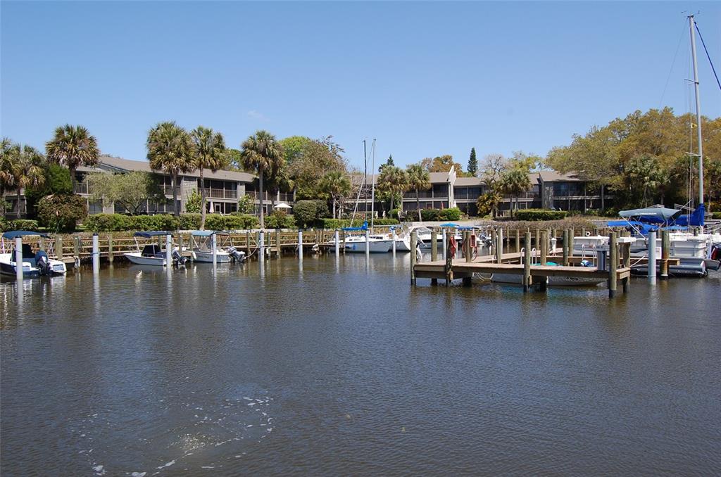 1720 Glenhouse Drive, Unit GL429 Sarasota, FL 34231 - Photo 25 of 34 a view of a lake with boats and trees in the background