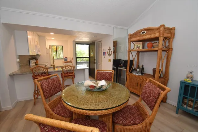 a dining room with furniture and wooden floor