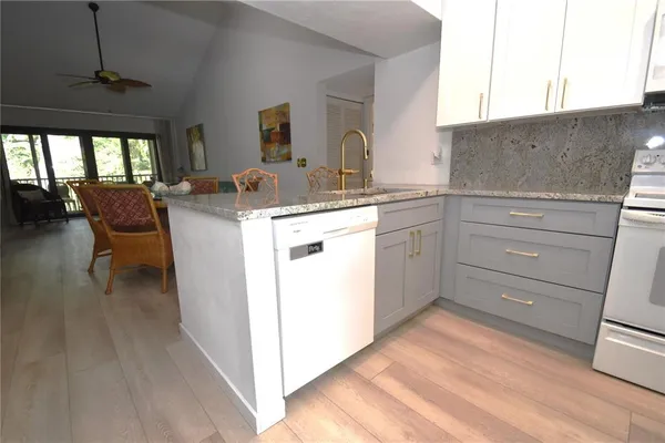 a kitchen with a stove a sink and a refrigerator