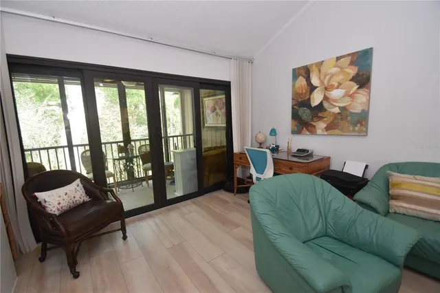 a living room with furniture and a floor to ceiling window