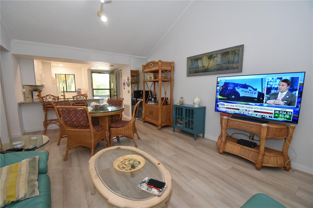 1720 Glenhouse Drive, Unit GL429 Sarasota, FL 34231 - Photo 10 of 34 a living room with furniture and a flat screen tv