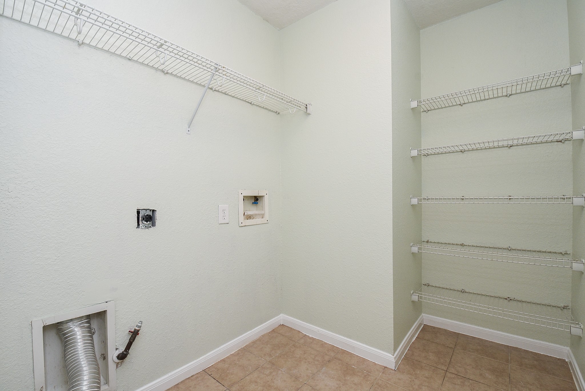 29323 Hickory Terrace Drive Spring, TX 77386 - Photo 28 of 32 Laundry room has plenty of storage space for your favorite detergents and laundry needs nestled to the side of your washer/dryer area