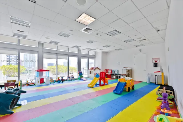 a play room with furniture and a large window