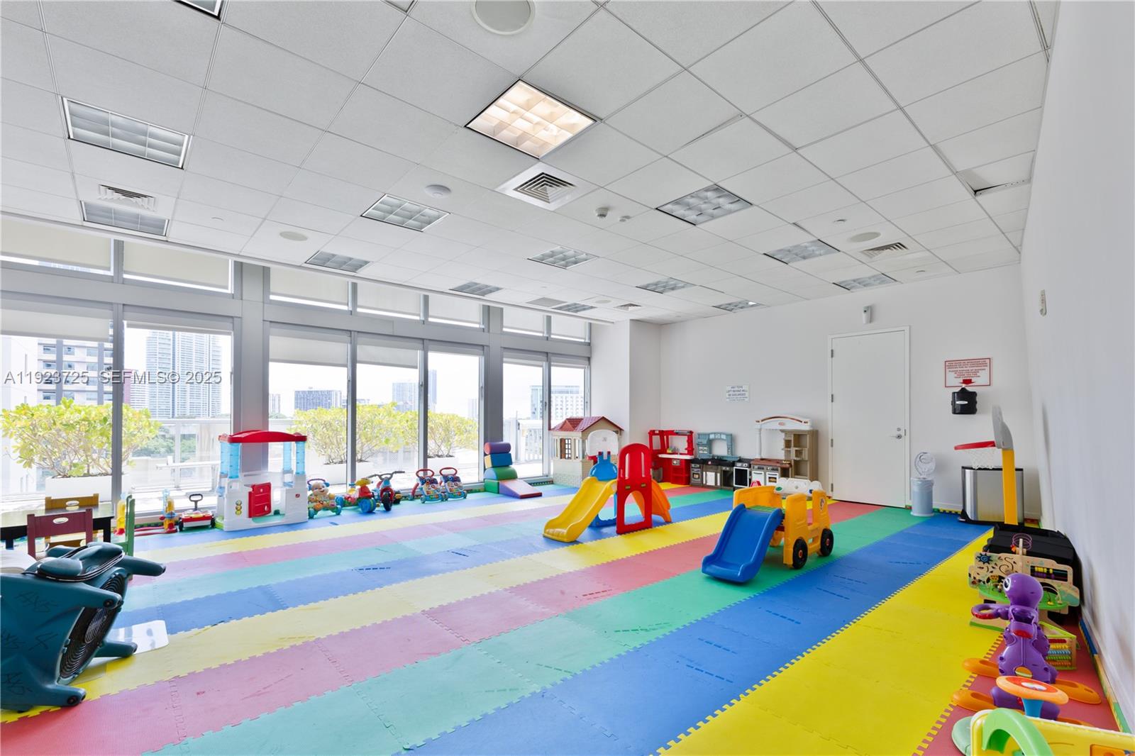 1111 Southwest 1st Avenue, Unit 2614N Miami, FL 33130 - Photo 25 of 32 a play room with furniture and a large window