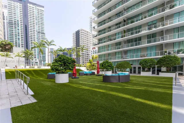 a front view of building with yard and green space