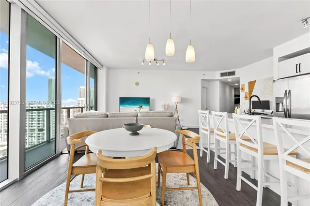 a dining room with furniture a rug and wooden floor