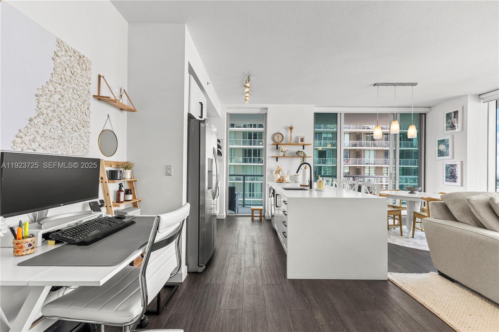 1111 Southwest 1st Avenue, Unit 2614N Miami, FL 33130 - Photo 8 of 32 a living room with furniture and a flat screen tv