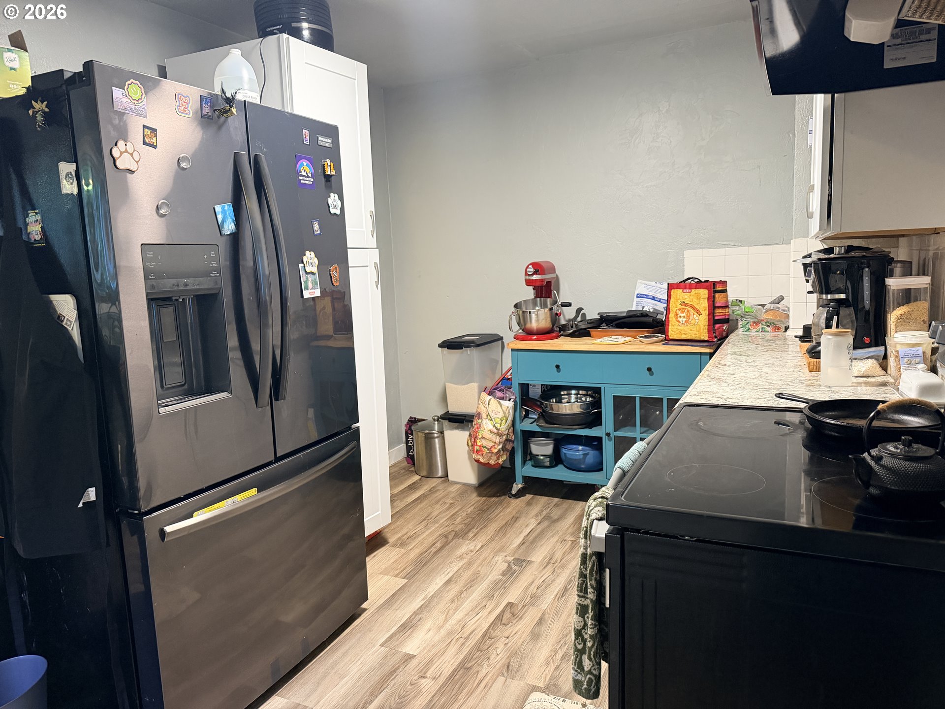 677 Southeast Moffitt Road Waldport, OR 97394 - Photo 16 of 36 a kitchen with refrigerator and table