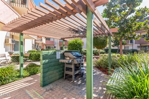 a view of a patio with table and chairs and potted plants
