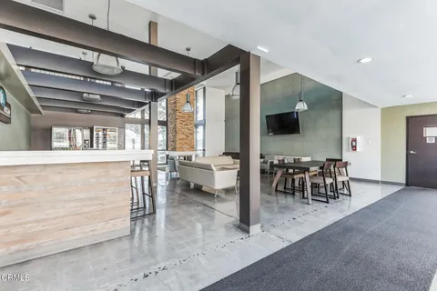 a view of a dining room with furniture water view and a kitchen view