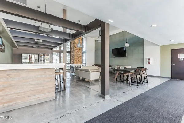 a view of a dining room with furniture water view and a kitchen view