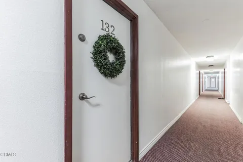 a view of a hallway to a hallway