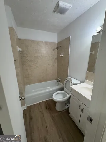 a bathroom with a toilet a sink and bathtub