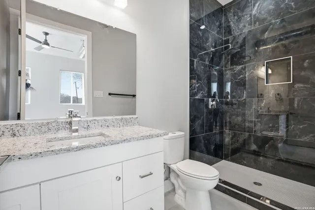 a bathroom with a sink toilet and shower