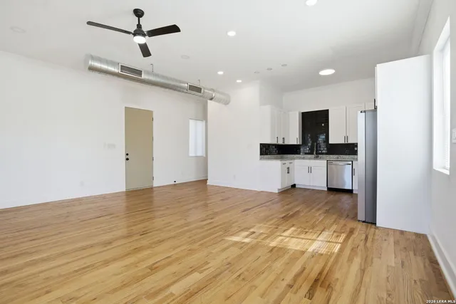 a view of a kitchen with a sink and a refrigerator