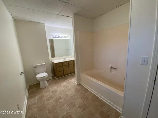 a bathroom with a tub toilet and a sink