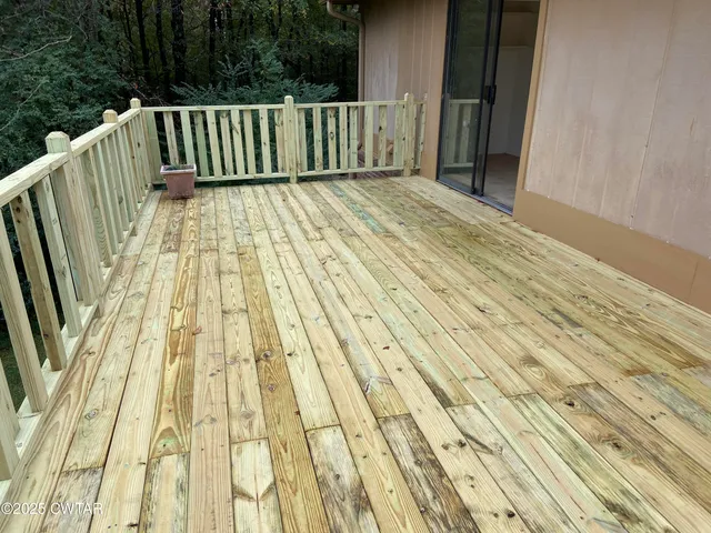 a view of balcony with wooden floor