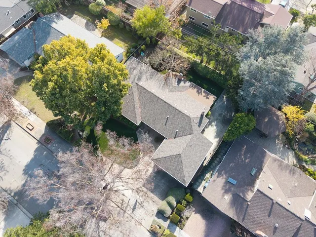 an aerial view of a house with a yard and garden