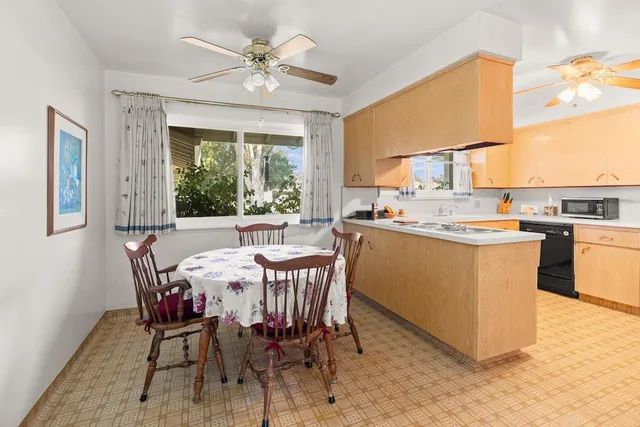 a dining room with a sink a counter and chairs