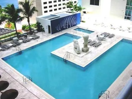 a view of swimming pool with a chair and tables