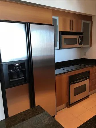 a kitchen with a refrigerator stove and microwave