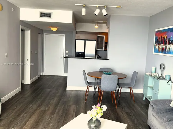 a view of a dining room with furniture and wooden floor