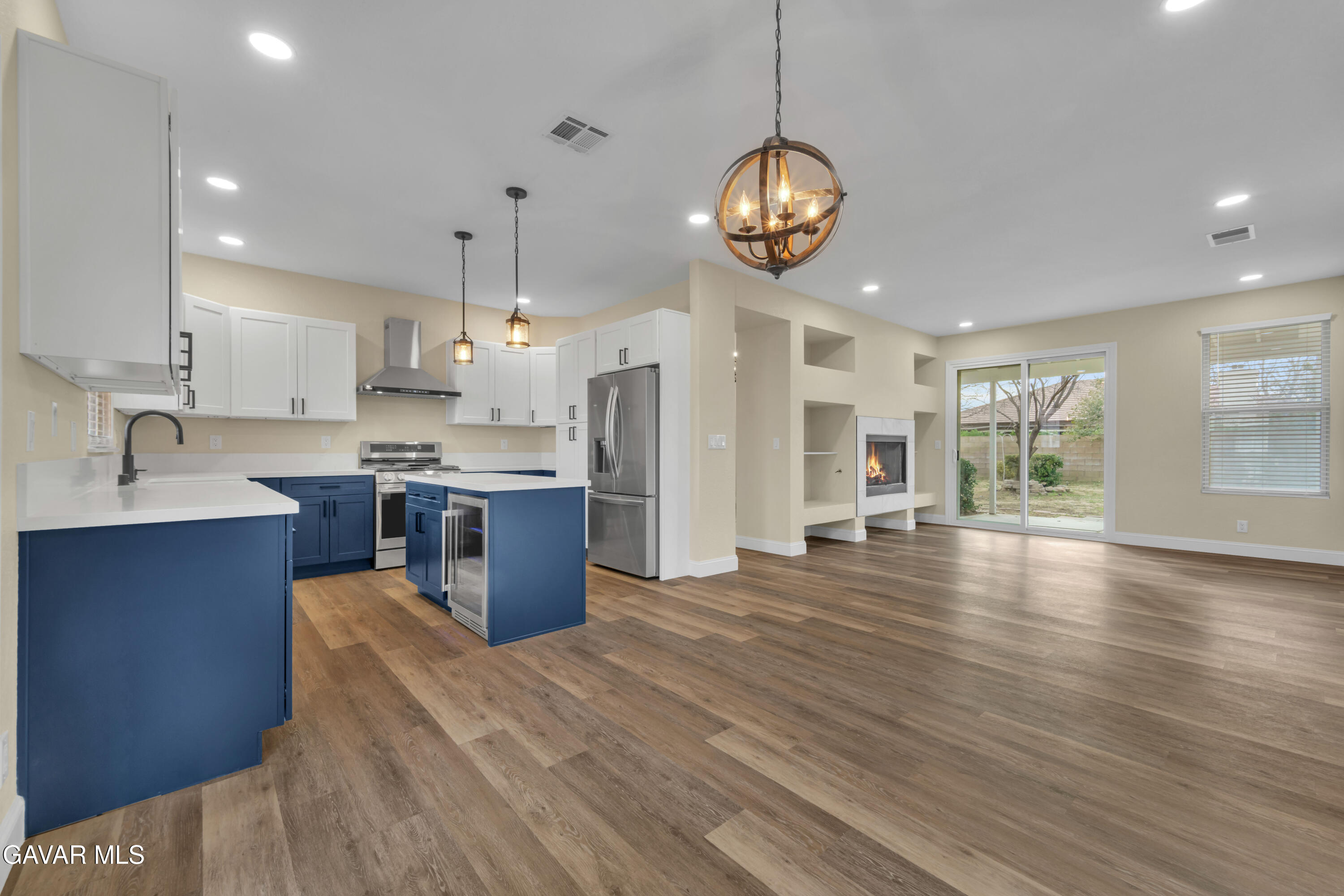 a large kitchen with stainless steel appliances kitchen island granite countertop a large island in the center