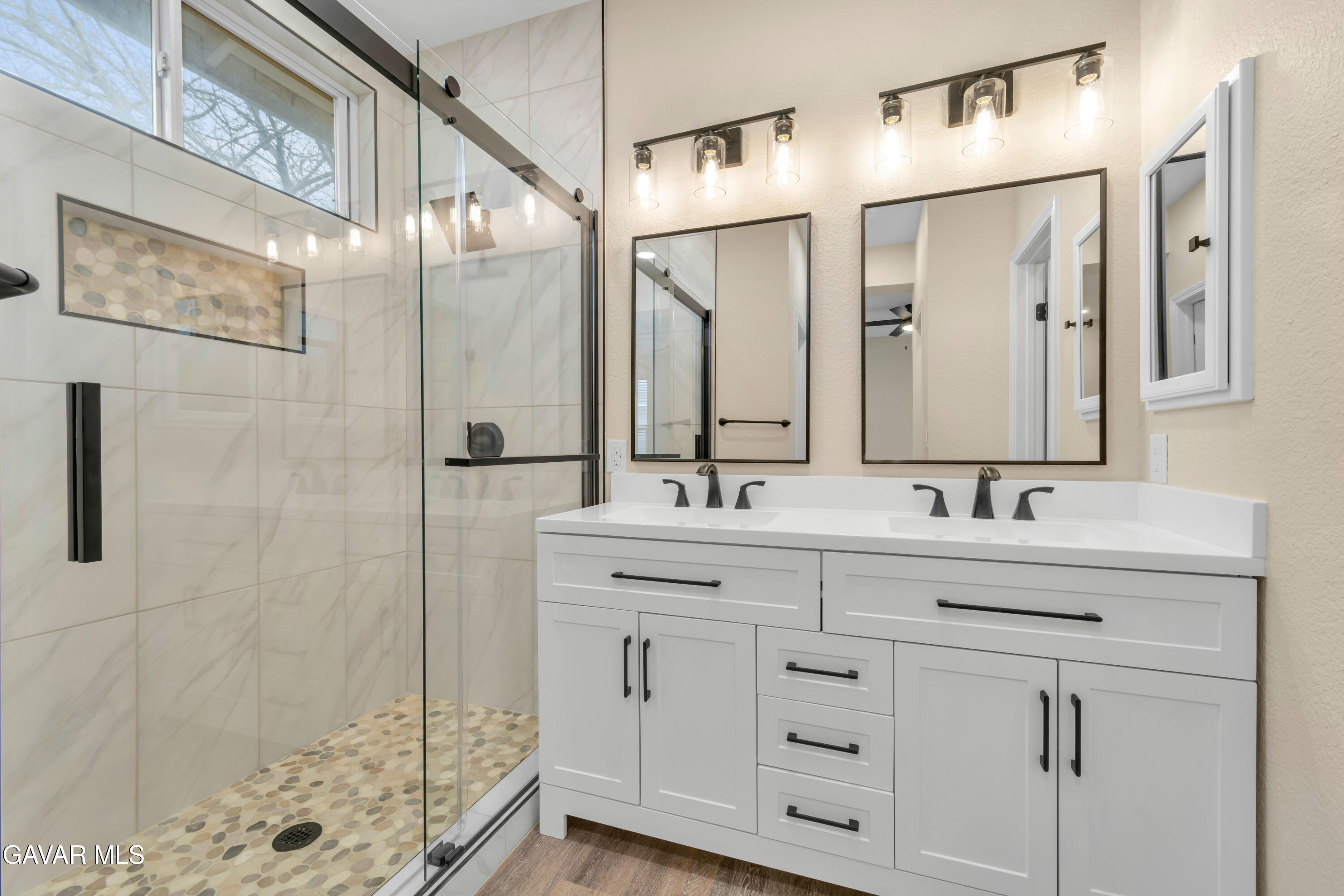 43323 Honeybee Lane Lancaster, CA 93536 - Photo 12 of 32 a bathroom with a double vanity sink mirror and shower