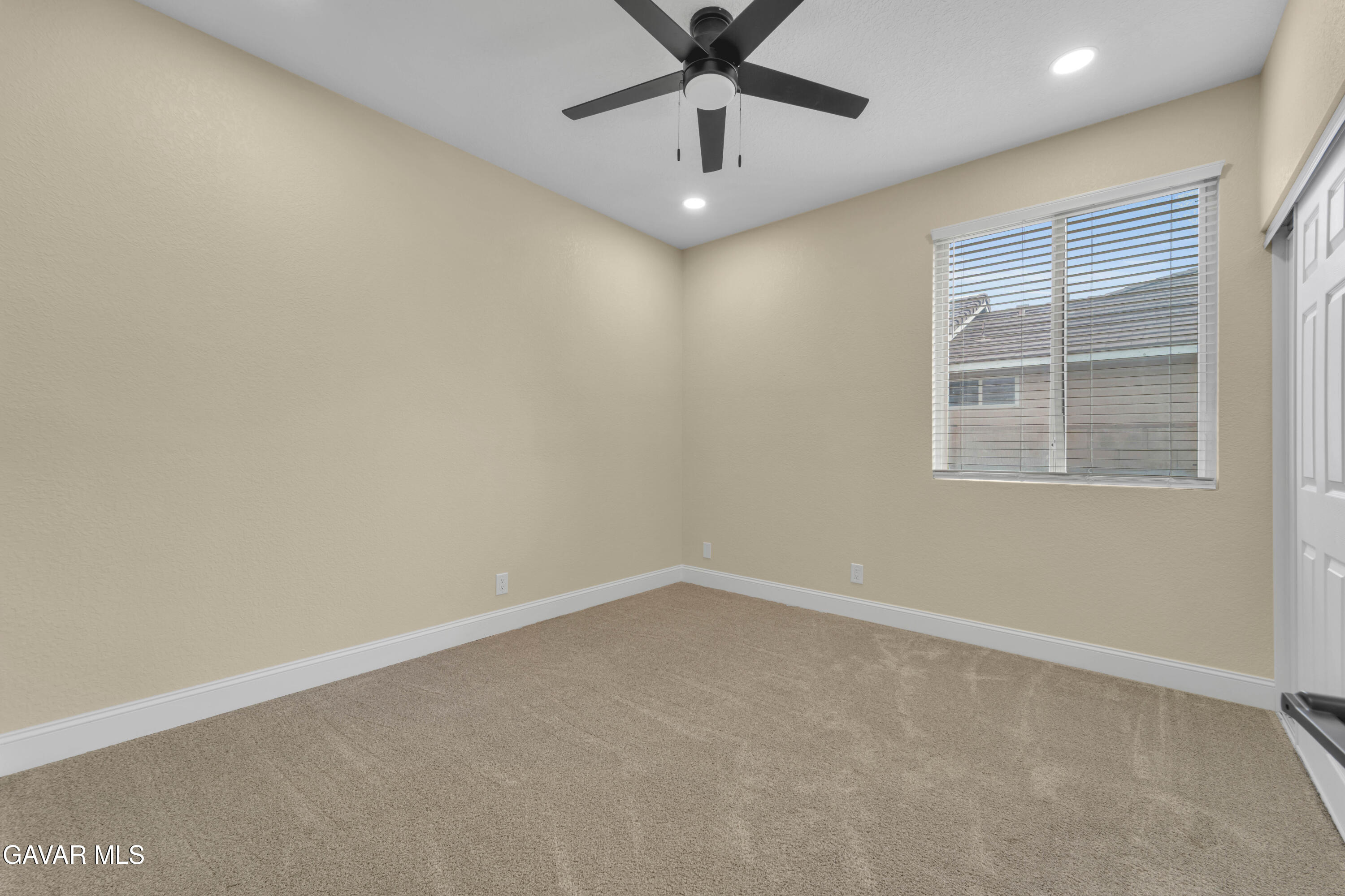 43323 Honeybee Lane Lancaster, CA 93536 - Photo 13 of 32 an empty room with a window and a fan