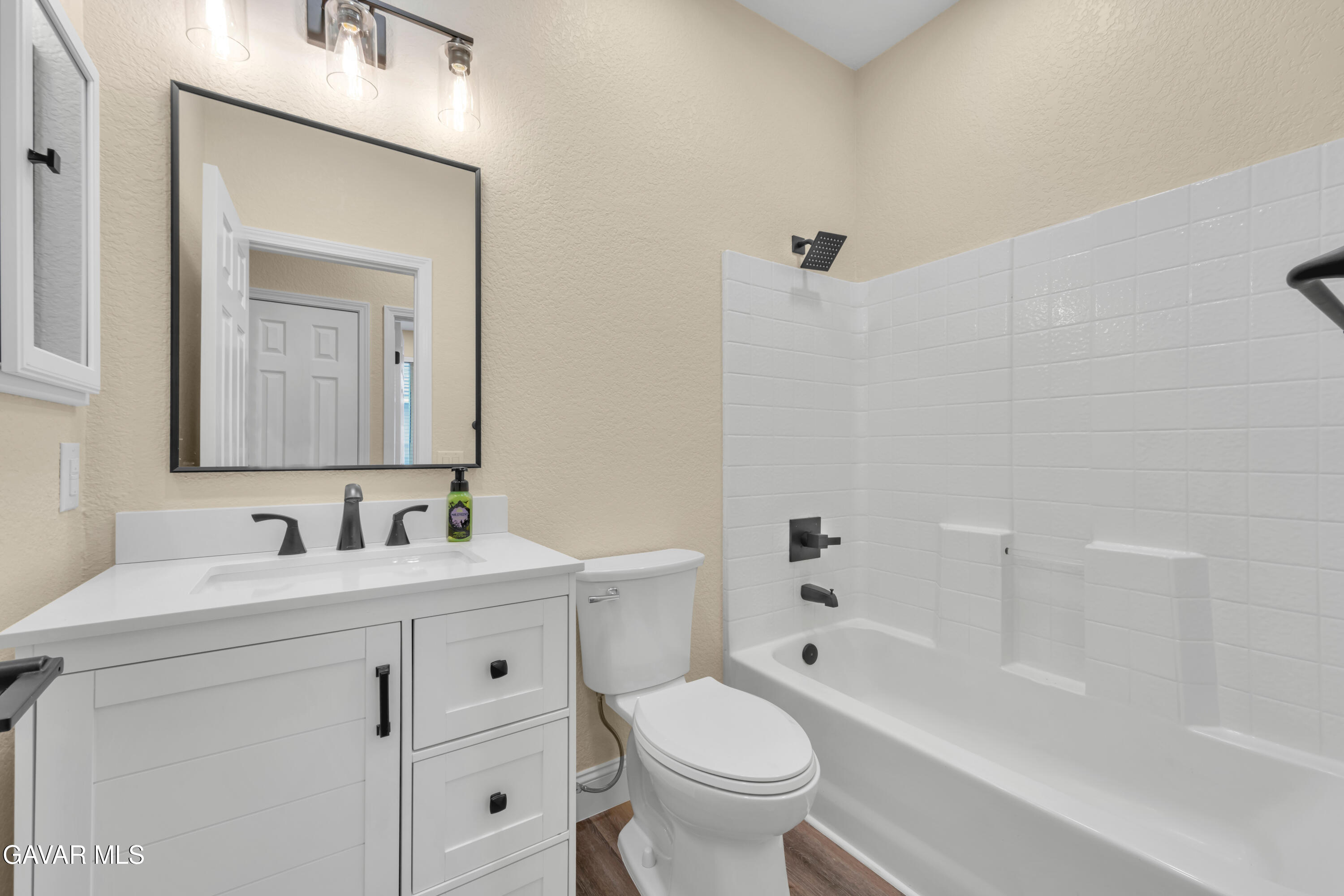 43323 Honeybee Lane Lancaster, CA 93536 - Photo 14 of 32 a bathroom with a toilet sink vanity tub and mirror