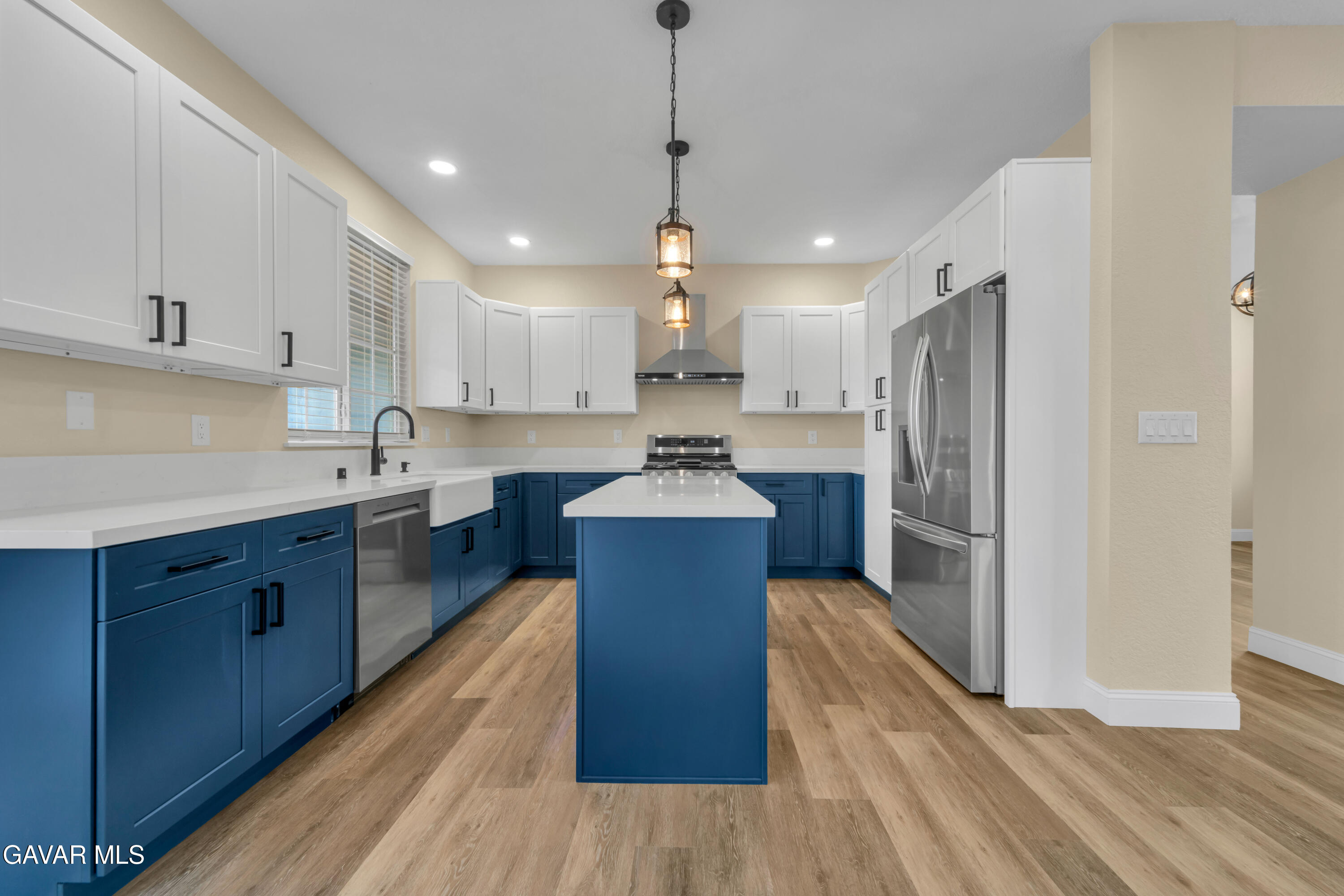 43323 Honeybee Lane Lancaster, CA 93536 - Photo 22 of 32 a kitchen with kitchen island stainless steel appliances sink refrigerator dining table and chairs