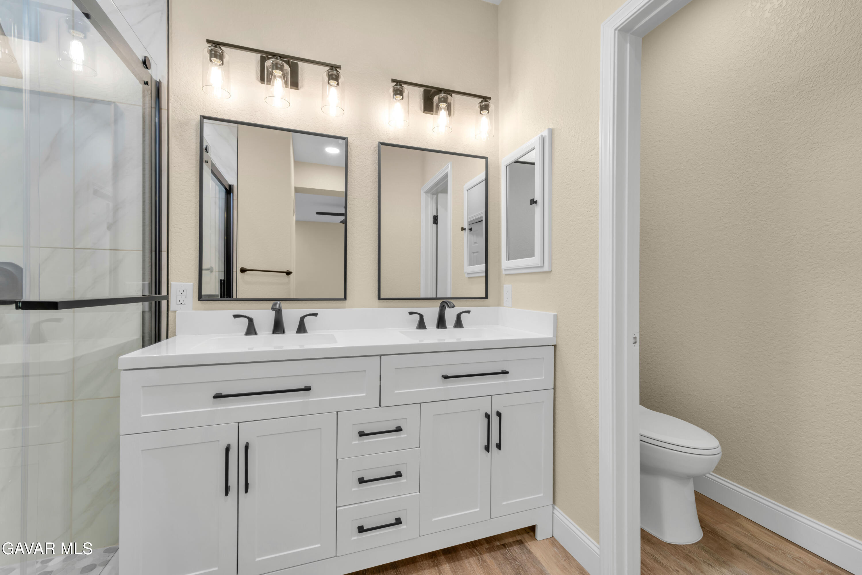 43323 Honeybee Lane Lancaster, CA 93536 - Photo 24 of 32 a bathroom with a toilet sink and mirror