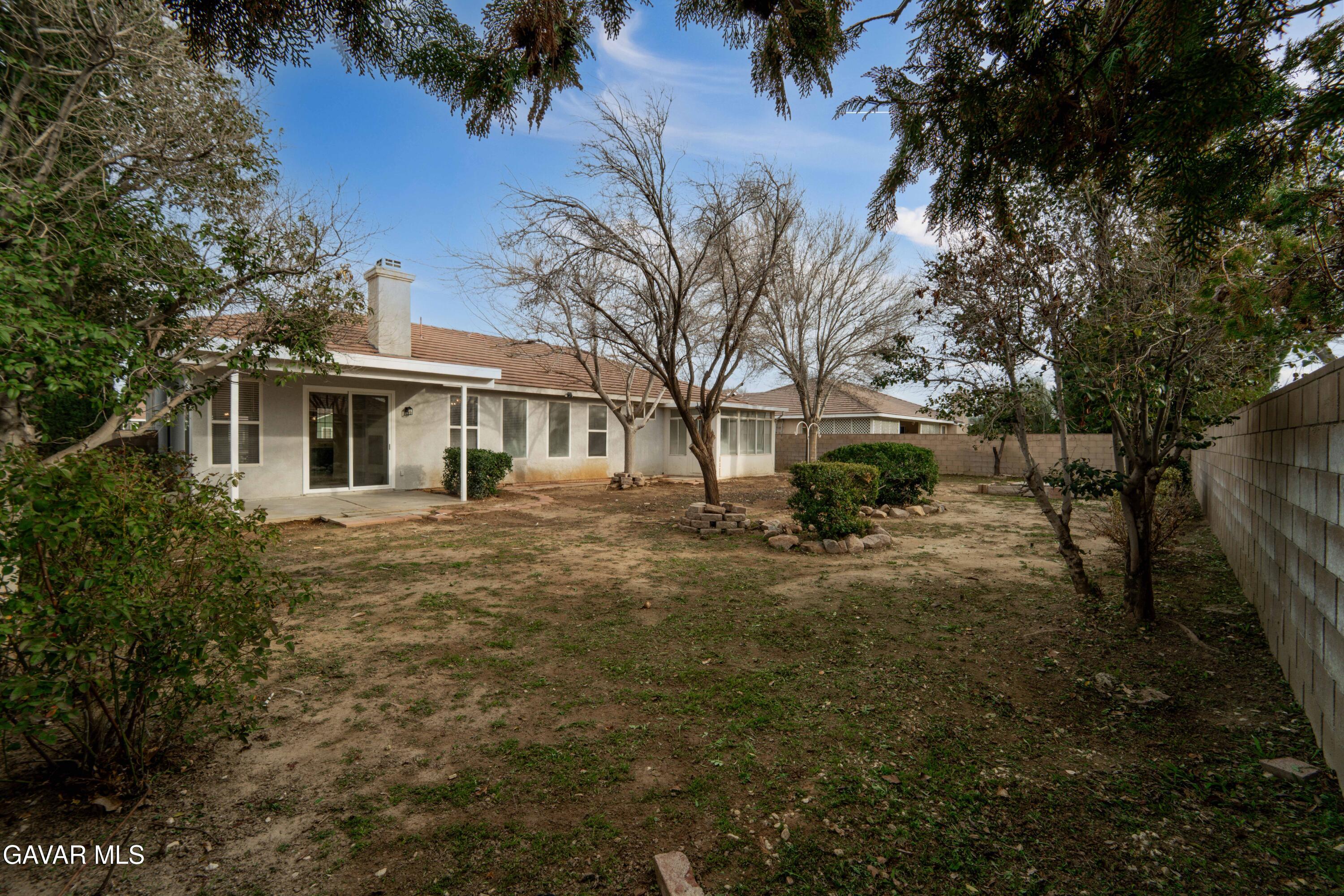 43323 Honeybee Lane Lancaster, CA 93536 - Photo 27 of 32 a front view of a house with a yard